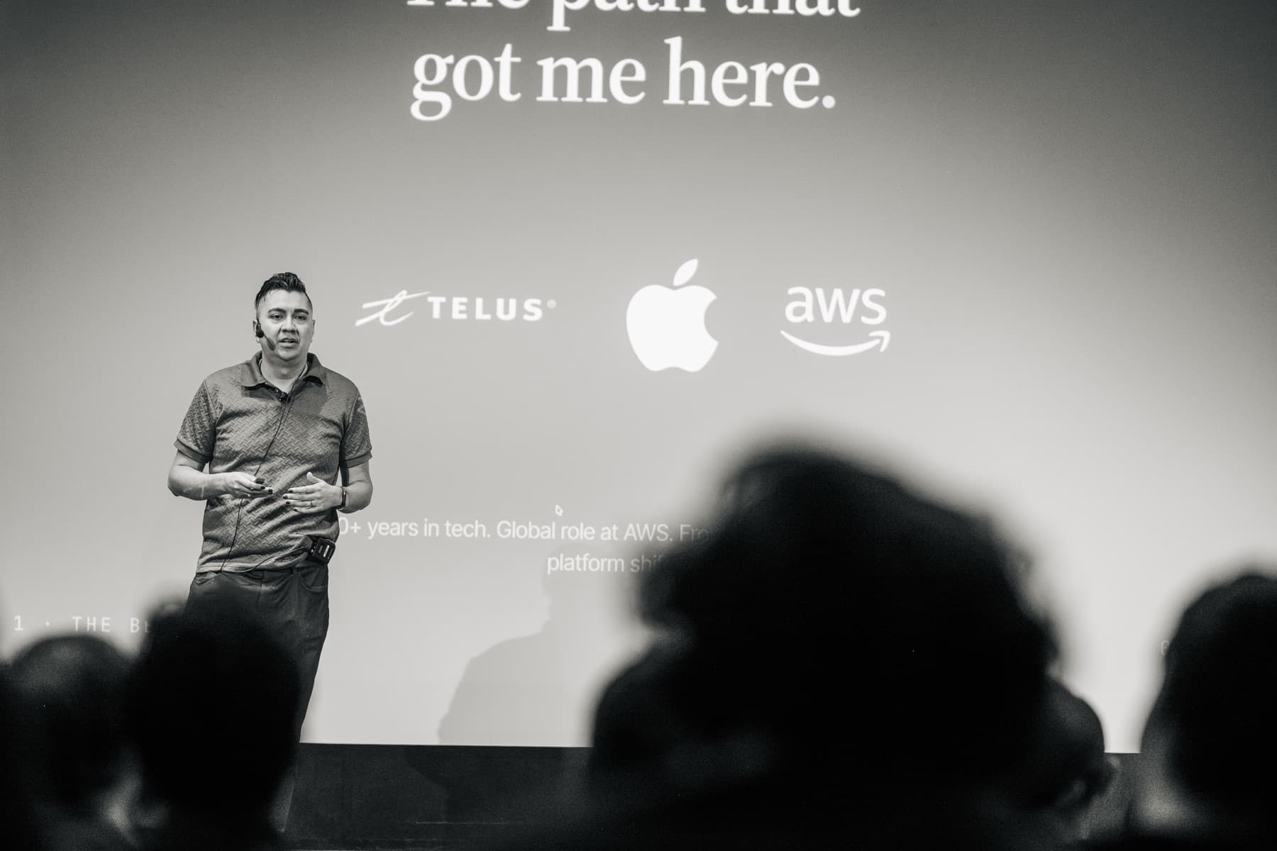 Gabriel Velazquez presenting under a slide titled The path that got me here, showing TELUS, Apple and AWS logos